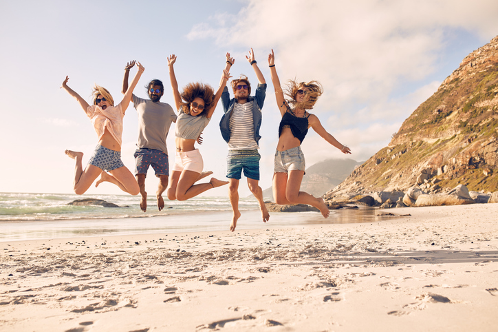 Group of friends on the beach having fun